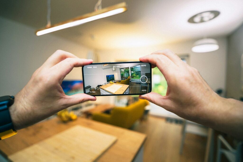 A person taking a picture with a cell phone