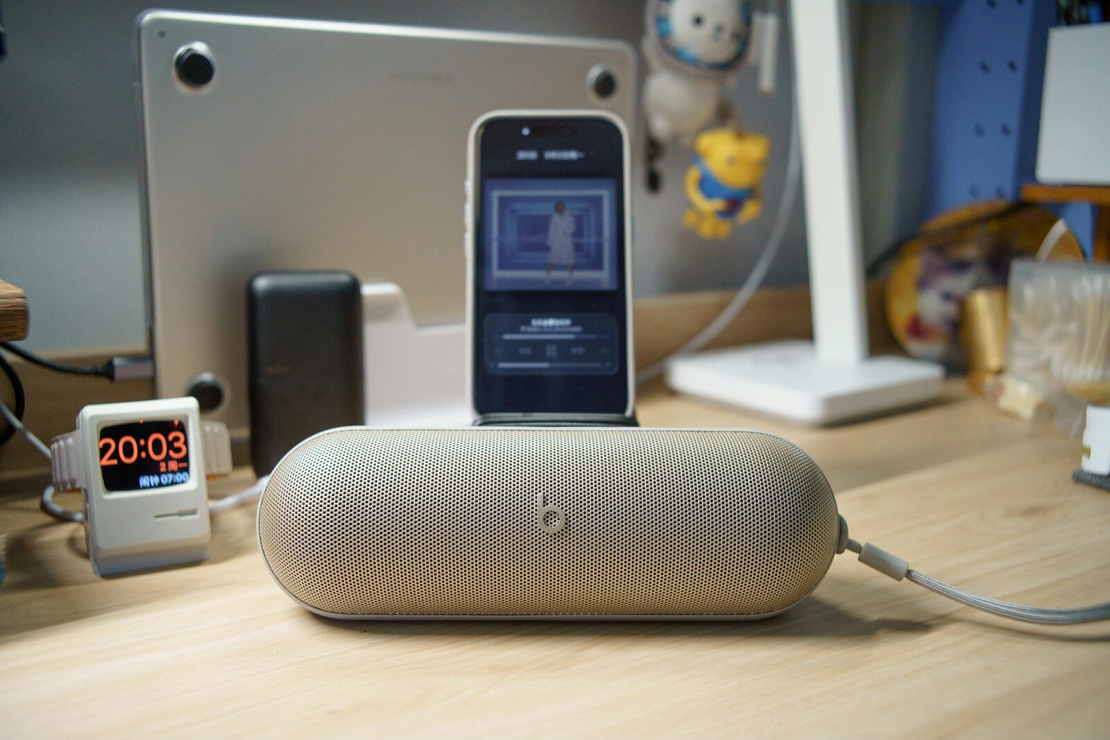 A smartphone rests on a portable speaker.